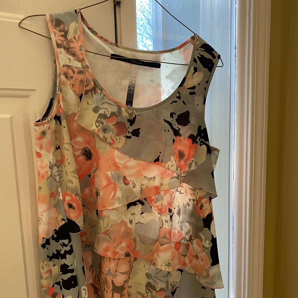 Cute ruffled shell. Great gif under a suit coat or a longer cartigen